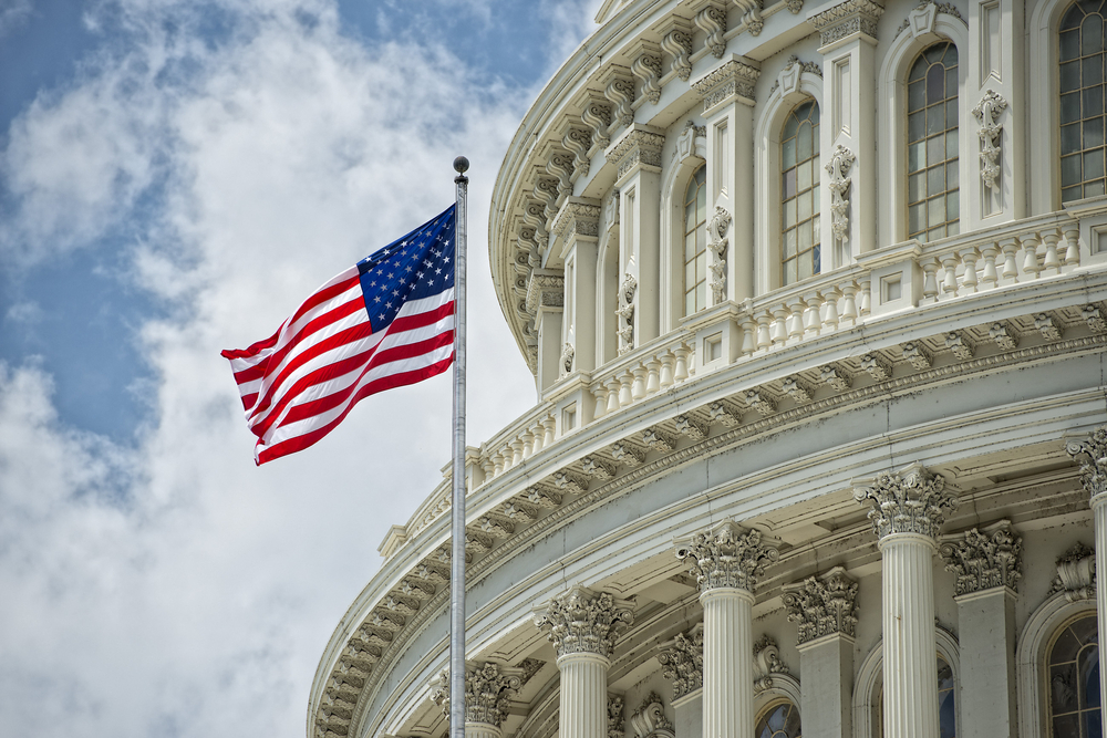 Waving American flag in front of the Capitol dome