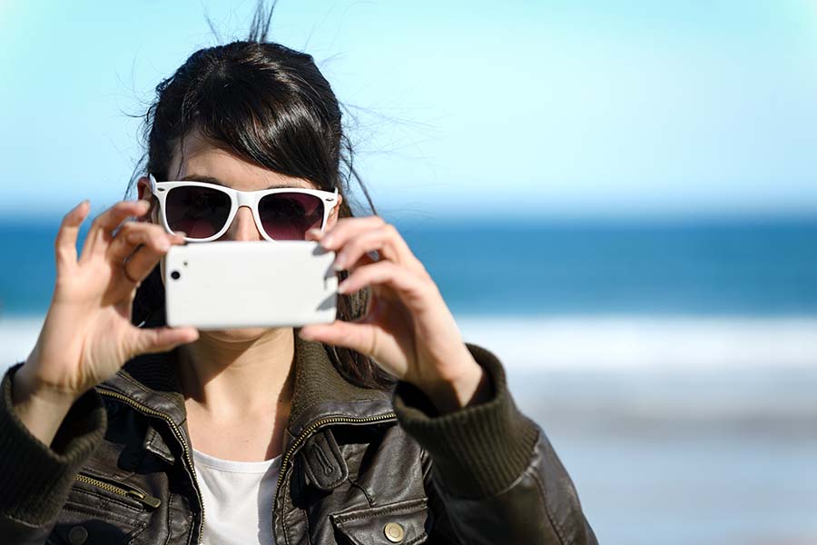 A woman taking a photo with her i-phone