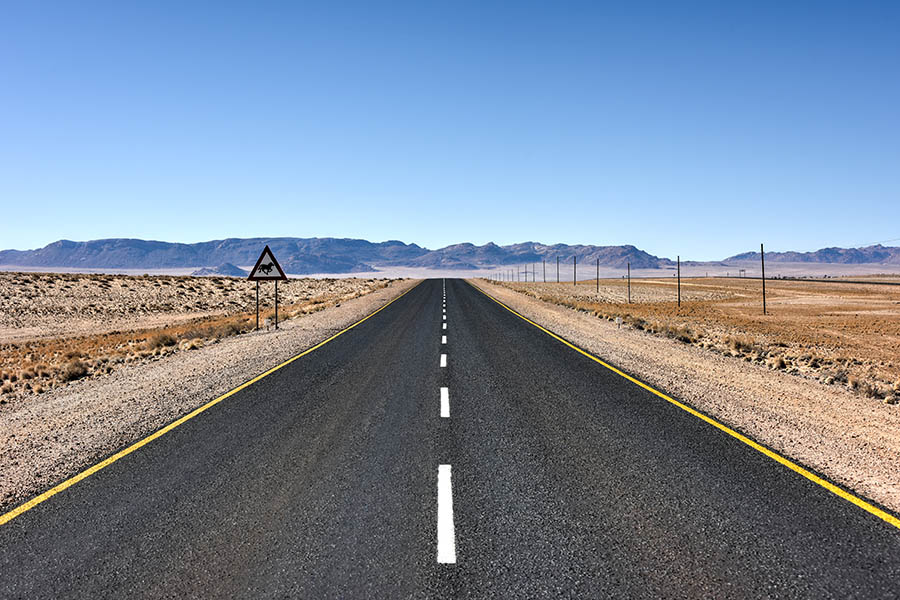 Driving along an empty road in the Namib desert