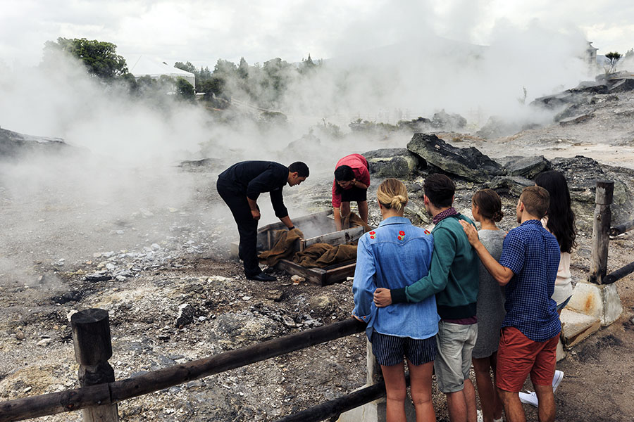 Try a traditional "hangi" (meat and veg cooked in an underground oven) | photo credit: Adam Bryce