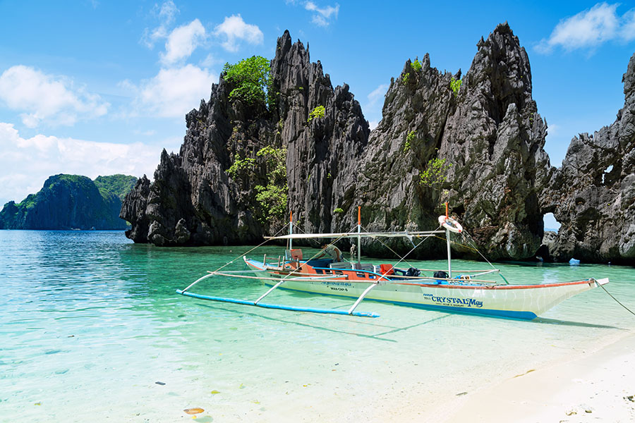 Sail between the islands on a banca (traditional Filipino out-rigger boat)